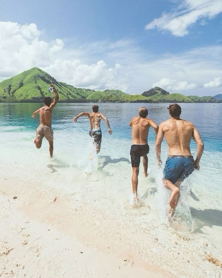 Friends running into turquoise water
